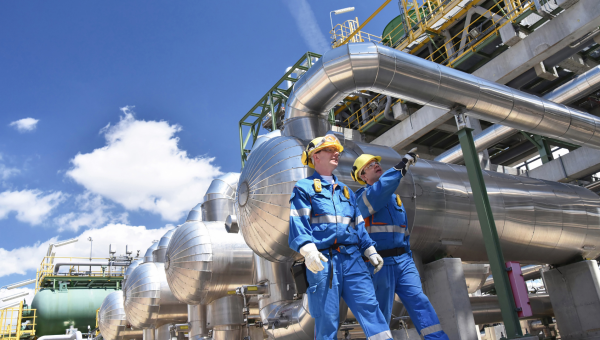 Two engineers outside outside of processing plant